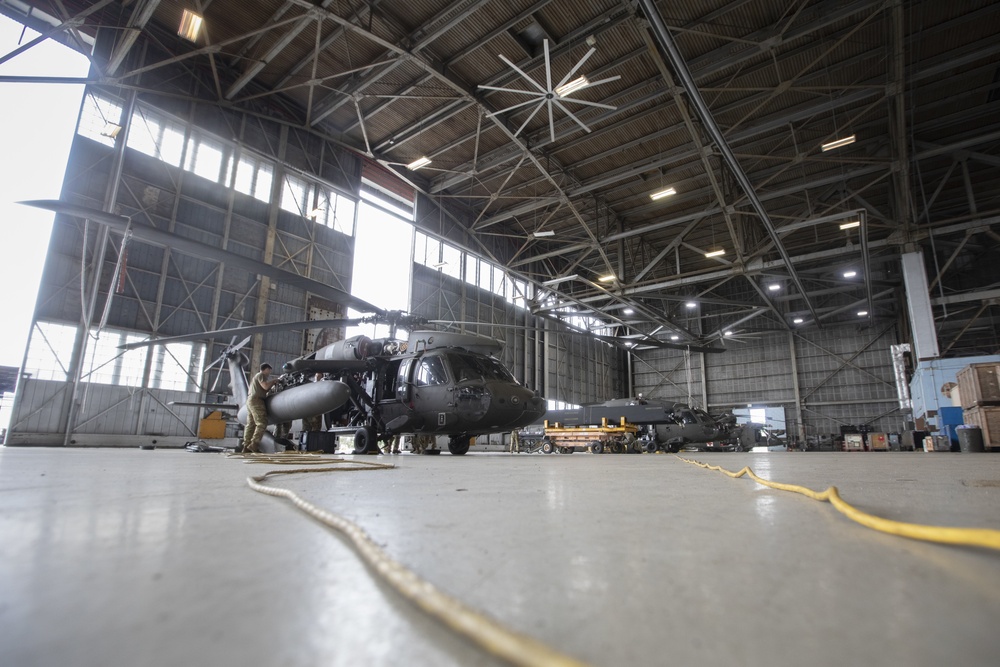 Marne Air Soldiers conduct maintenance on a UH-60 Black Hawk helicopter.