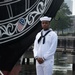 Seaman Diego Speight poses for a photo in front of USS Constitution