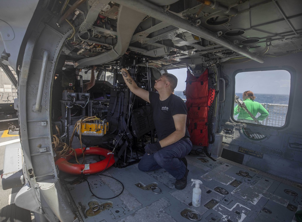 HSC 28 Sailor Cleans the Interior of an MH-60S Seahawk Helicopter