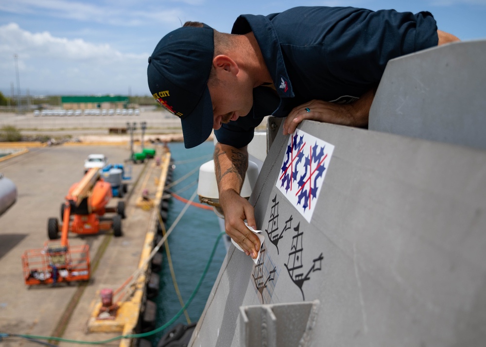 USS Sioux City Sailor Applies Decals