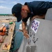 USS Sioux City Sailor Applies Decals