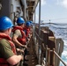 USS Germantown sailors heave messenger line.