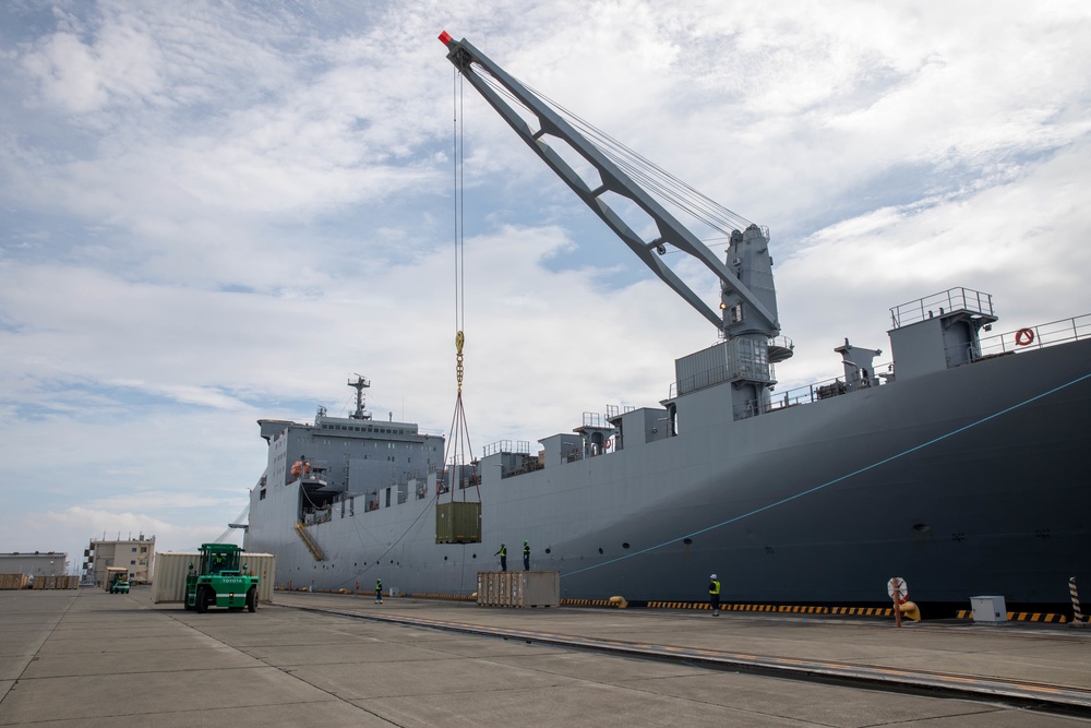 Personnel with the 836th Transport Battalion load cargo onto USNS Fisher