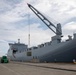 Personnel with the 836th Transport Battalion load cargo onto USNS Fisher