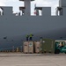 Personnel with the 836th Transport Battalion load cargo onto USNS Fisher