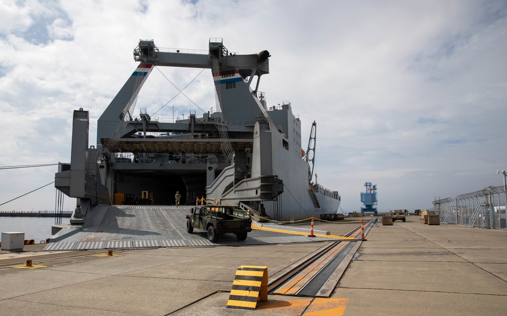 Personnel with the 836th Transport Battalion load cargo onto USNS Fisher