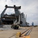 Personnel with the 836th Transport Battalion load cargo onto USNS Fisher