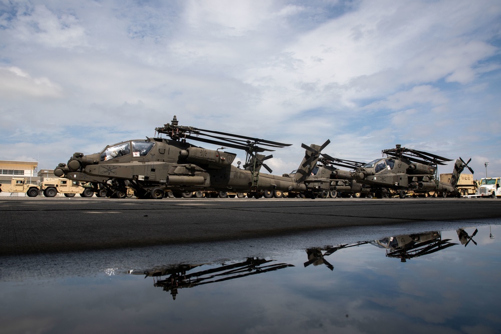 Personnel with the 836th Transport Battalion load cargo onto USNS Fisher
