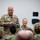 A U.S. Army general named Harris, identifiable by his name tape and a single star insignia indicating Brigadier General rank, is addressing a group of military personnel in what appears to be an indoor briefing or town hall setting. He is wearing OCP (Operational Camouflage Pattern) uniform with a U.S. flag patch and U.S. Army tape. The audience consists of multiple uniformed service members seated and listening attentively.