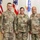 Three U.S. Army soldiers in Operational Camouflage Pattern (OCP) uniforms pose for a formal photo in front of multiple flags. Name tapes visible on two soldiers read 'LOCKER' and 'WILLIAMS', both with 'OHIO' state designators, while the third soldier on the right wears 'U.S. ARMY' tape and displays general officer rank insignia. The setting appears to be an official military ceremony or recognition event.