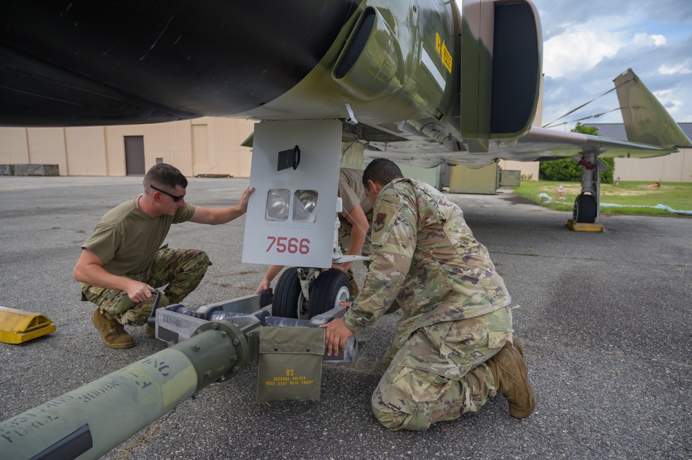 Team JSTARS maintainers tow an F-4C Phantom II to wing HQ for permanent static display