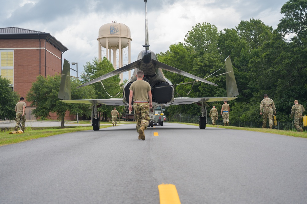 Team JSTARS maintainers tow an F-4C Phantom II to wing HQ for permanent static display