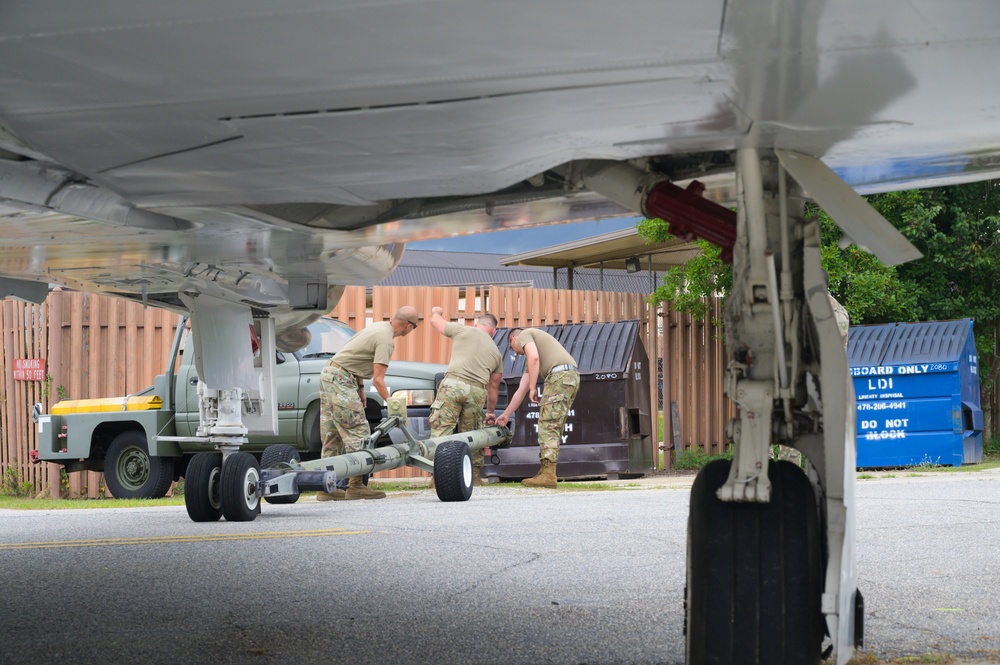 Team JSTARS maintainers tow an F-4C Phantom II to wing HQ for permanent static display