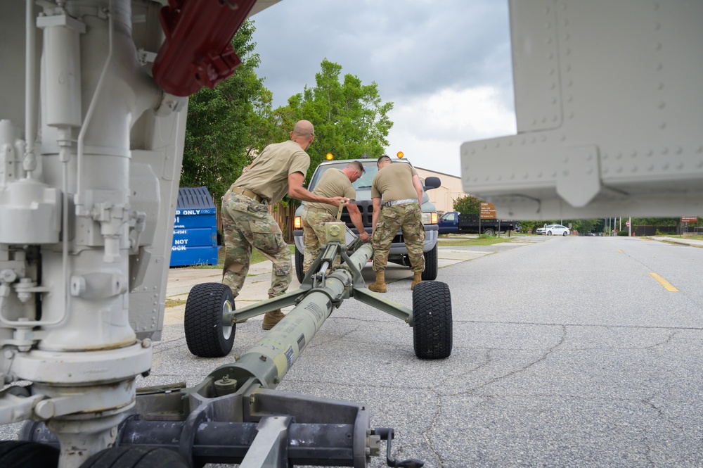 Team JSTARS maintainers tow an F-4C Phantom II to wing HQ for permanent static display