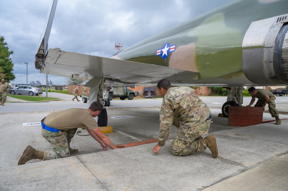 Team JSTARS maintainers tow an F-4C Phantom II to wing HQ for permanent static display