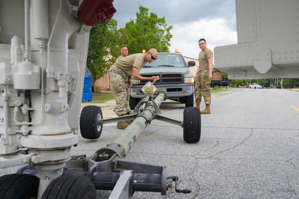 Team JSTARS maintainers tow an F-4C Phantom II to wing HQ for permanent static display