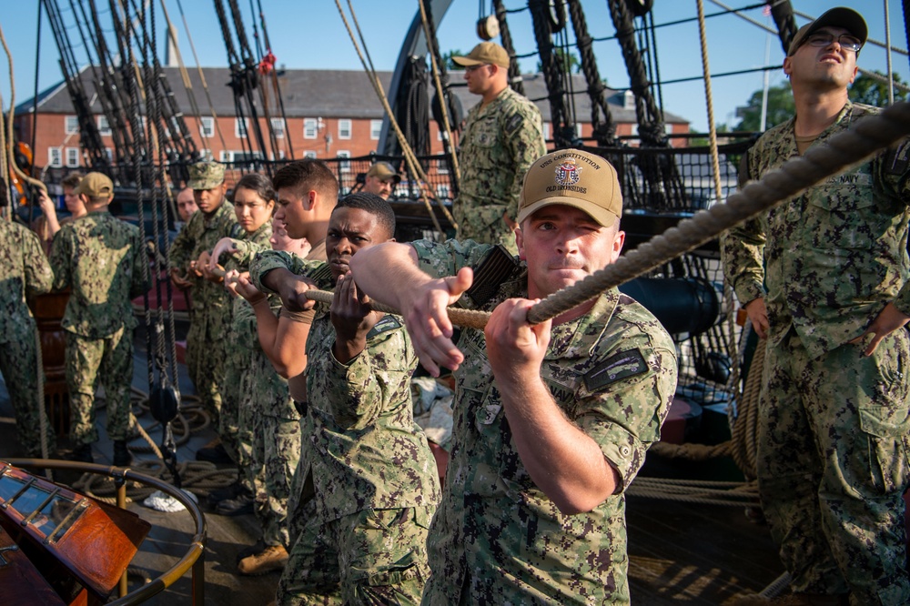 U.S. Sailors set spanker sail