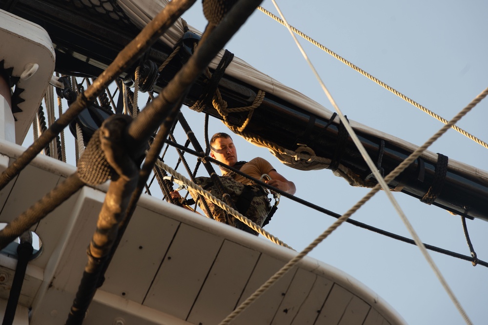 Seaman William Jones climbs the shrouds