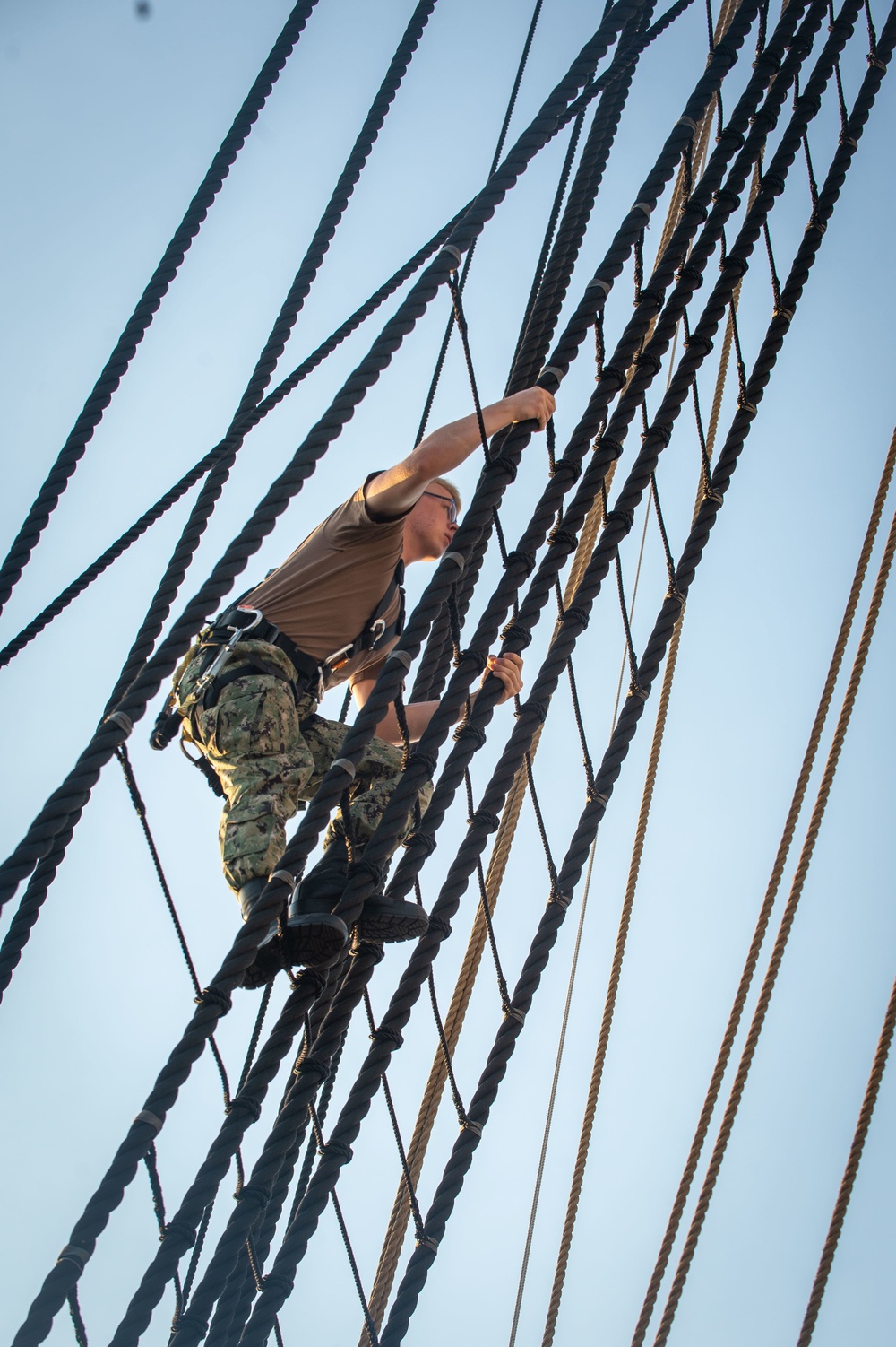 Airman Adam Cluckie climbs the shrouds