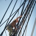 Airman Adam Cluckie climbs the shrouds