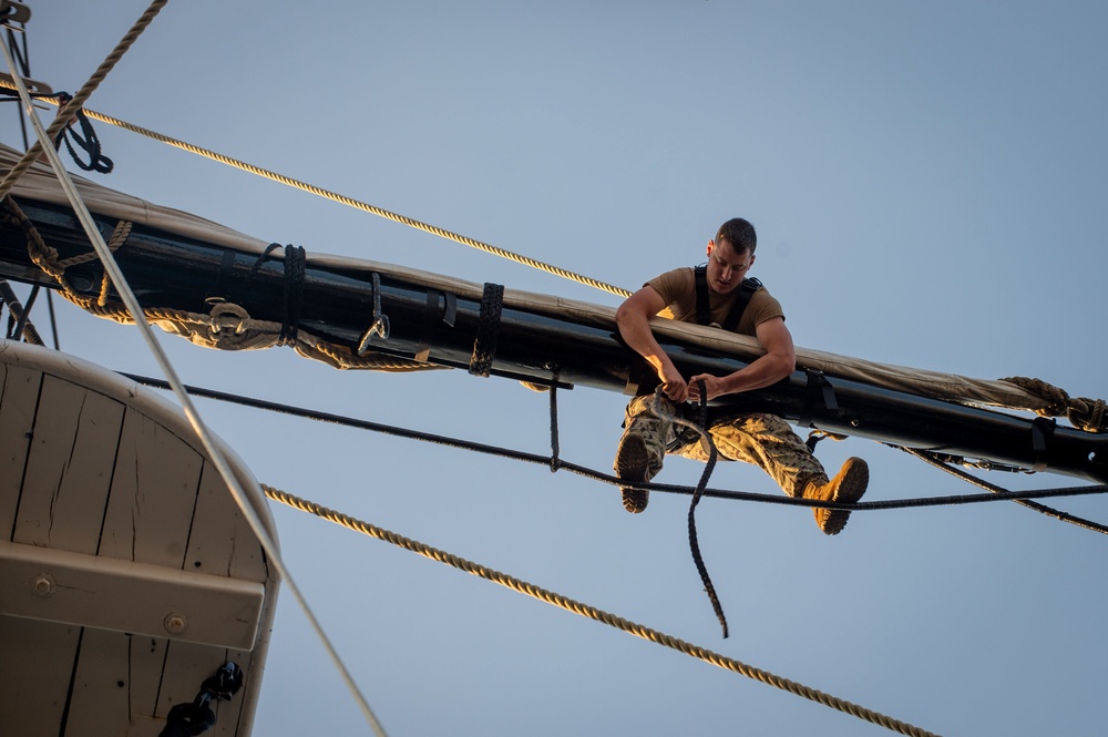 Seaman William Jones unfurls the mizzen top sail