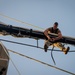 Seaman William Jones unfurls the mizzen top sail