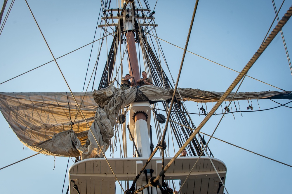 U.S. Sailors unfurl the mizzen top sail