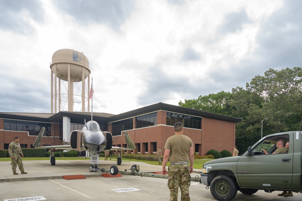 Team JSTARS maintainers tow an F-4C Phantom II to wing HQ for permanent static display