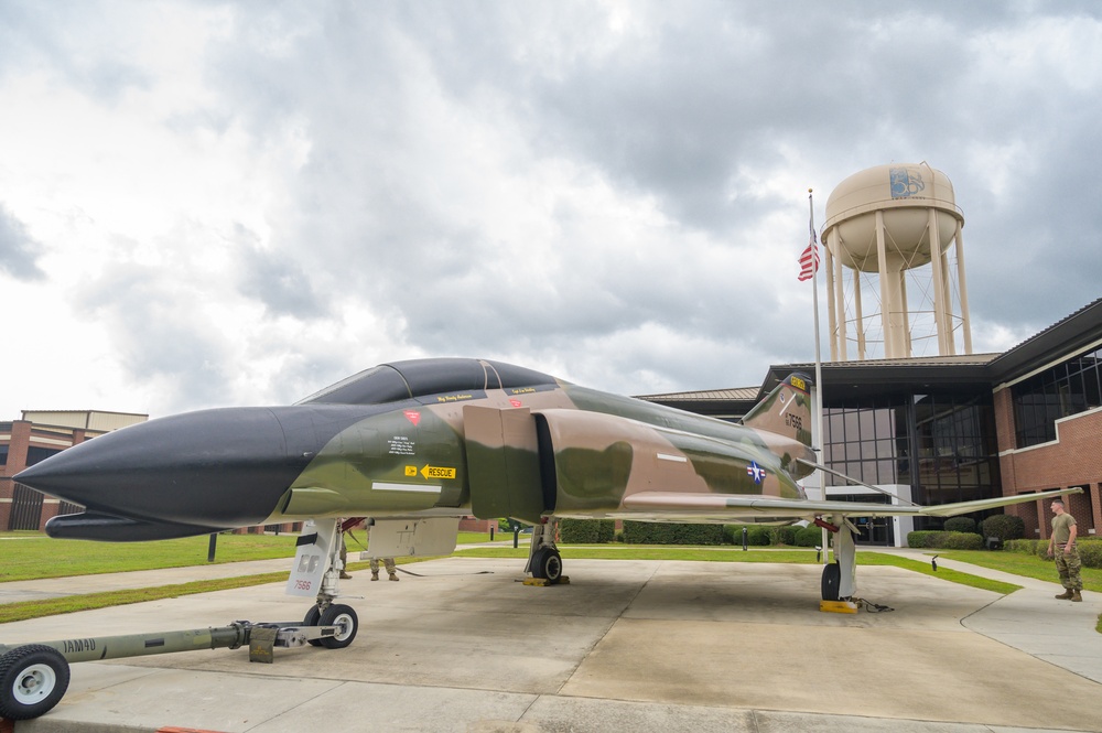 Team JSTARS maintainers tow an F-4C Phantom II to wing HQ for permanent static display