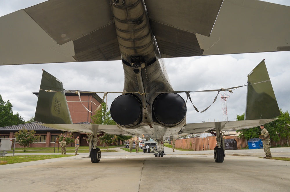 Team JSTARS maintainers tow an F-4C Phantom II to wing HQ for permanent static display