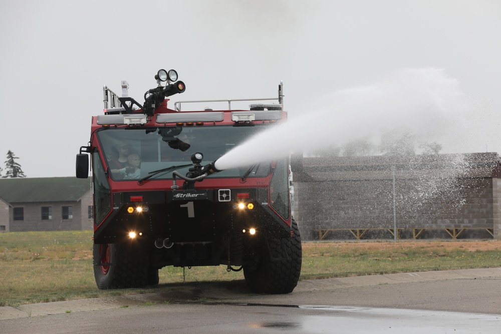 Firefighters at Camp Ripley give Ethan Manson firetruck tour