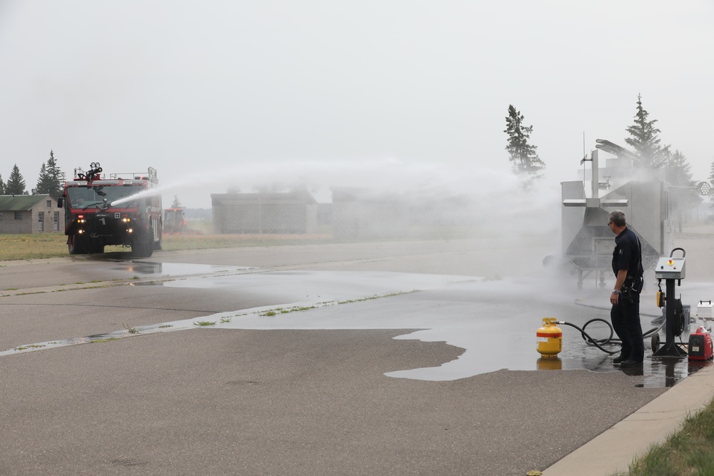 Firefighters at Camp Ripley give Ethan Manson firetruck tour