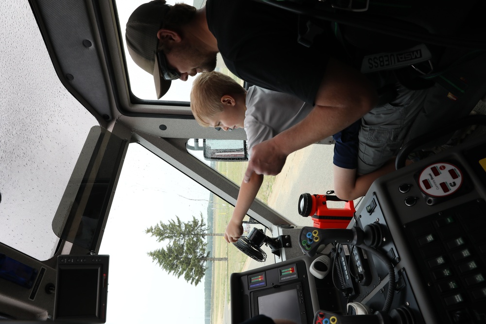 Firefighters at Camp Ripley give Ethan Manson firetruck tour