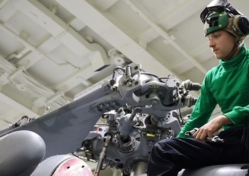 HSM-37 Sailor Conducts Maintenance On An MH-60R Sea Hawk
