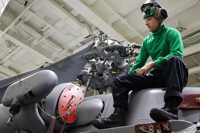 HSM-37 Sailor Conducts Maintenance On An MH-60R Sea Hawk