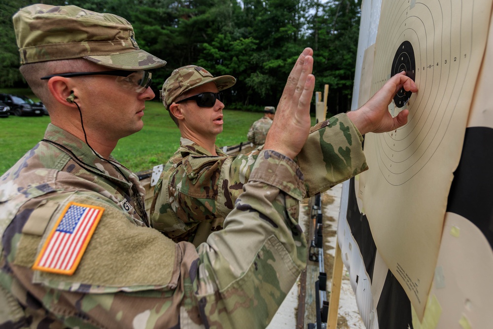 Sgt. Michael Yarrington and Maj. Zack Land discuss scoring after shooting an M17 pistol