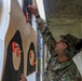 Staff Sgt. Devin Crawford marks hits after an M4 rifle firing event