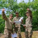 Capt. Sterling Broadhead teaches Sgt. Stanley Thompson and Sgt. Michael Yarrington basic orienteering skills