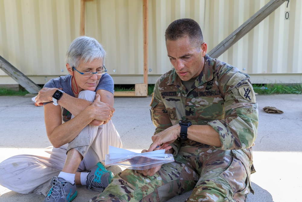 1st Lt. Joshua Moeller talks with Andi Berger about the orienteering practice event