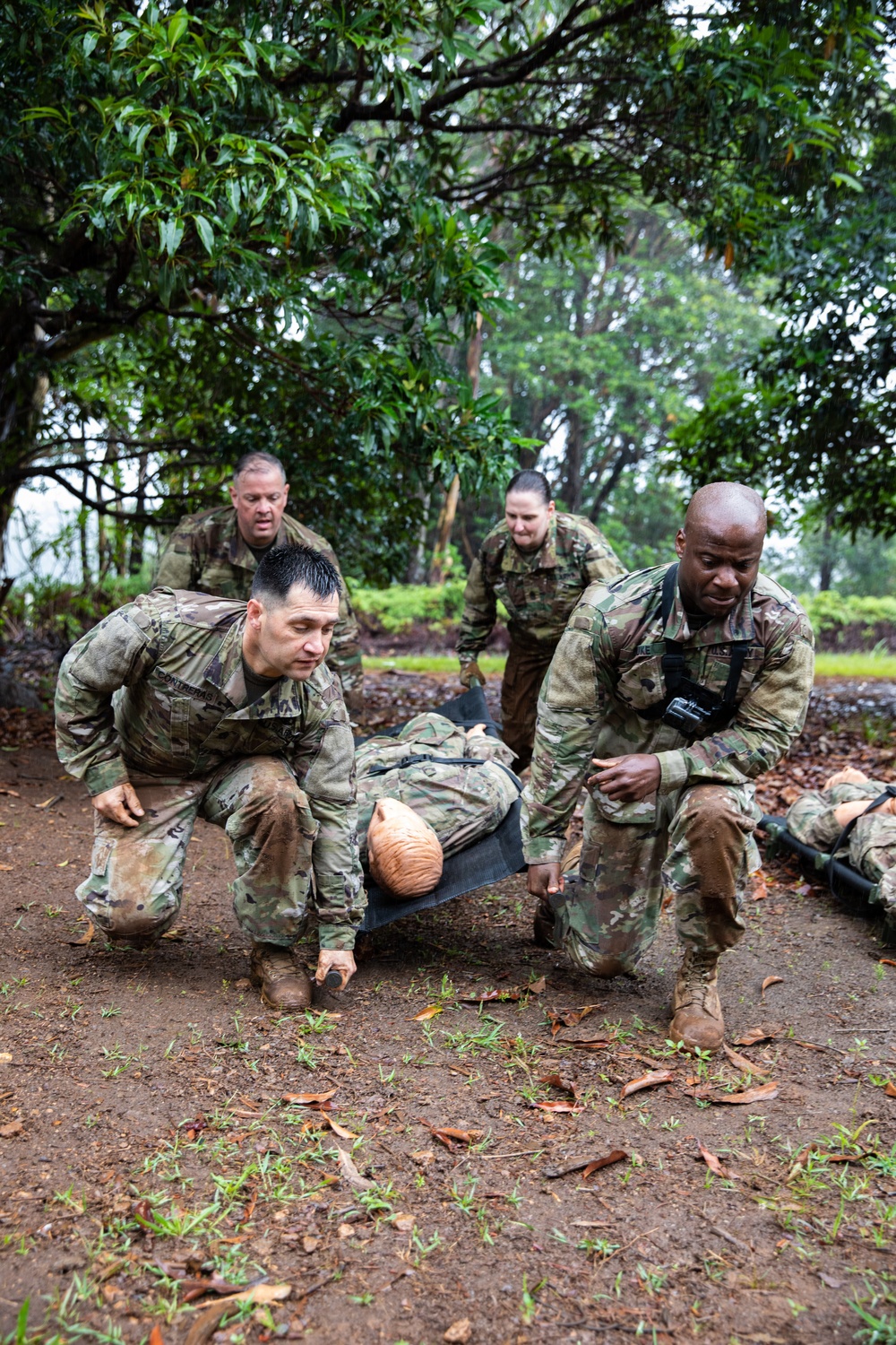 Sergeants Major of U.S Army Medical Command (MEDCOM) carry a litter as part of the Air Assault obstacle course