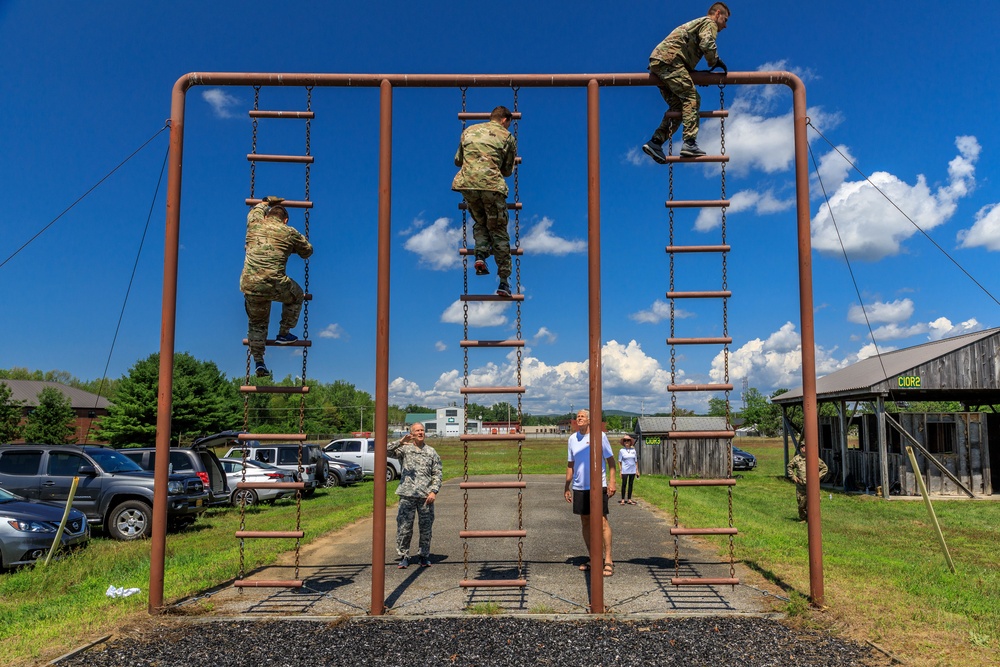 U.S. Reserve service members climb down an obstacle