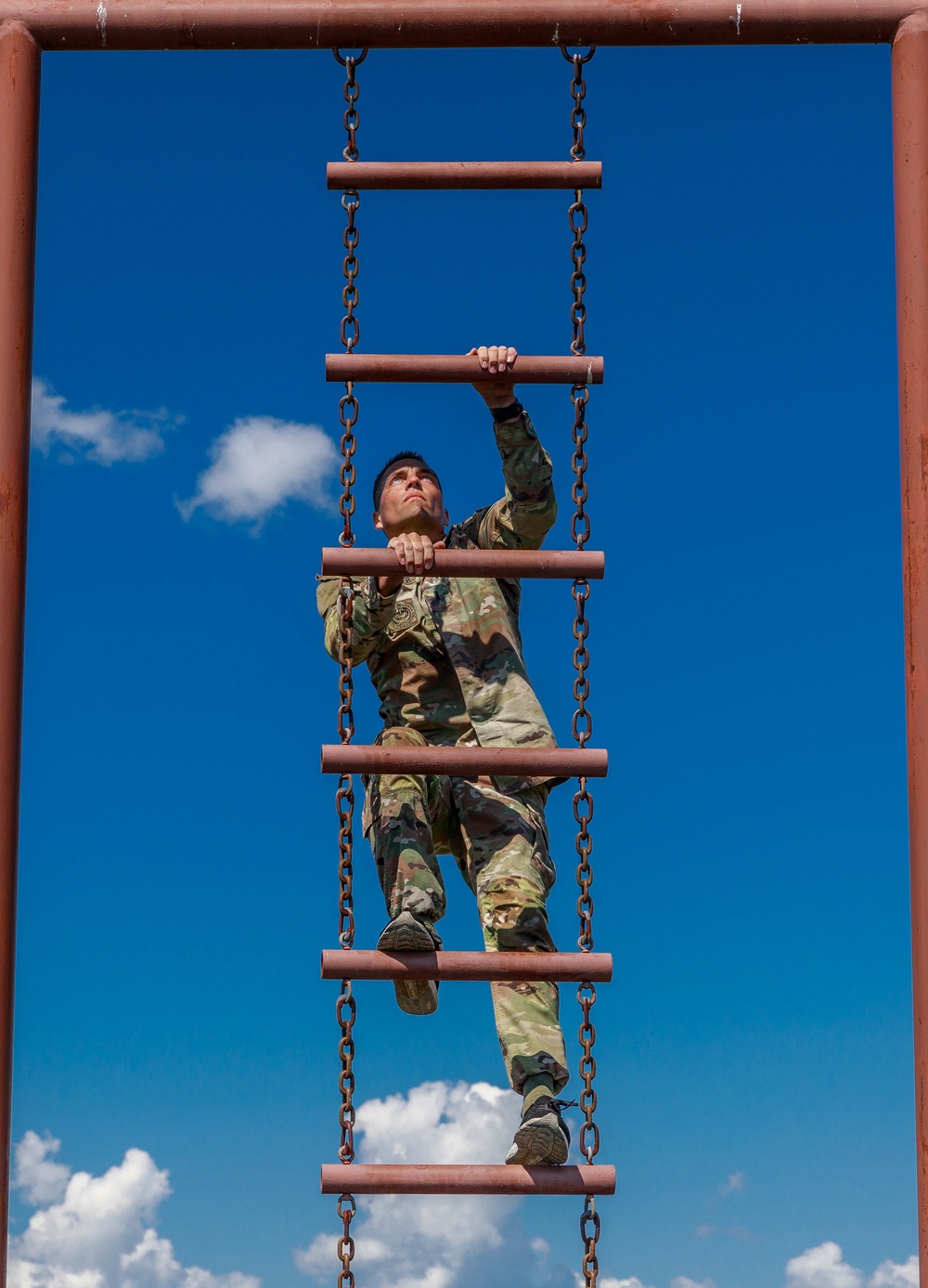 1st Lt. Joshua Moeller climbs an obstacle