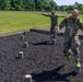 Staff Sgt. Devin Crawford and Col. Ryan “MZ” Montanez  step over an obstacle