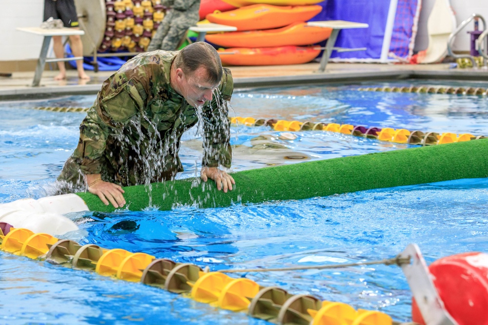 Sgt. 1st Class Shane Price swims over an obstacle