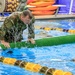 Sgt. 1st Class Shane Price swims over an obstacle