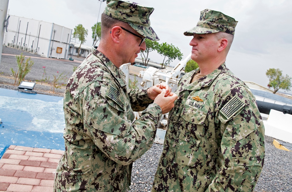McClure awarded Navy Expeditionary Supply Corps Officer Warfare pin