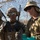 Talisman Sabre 21: U.S., Australian forces perform bilateral fuel training Three military personnel are gathered under a camouflage netting in what appears to be a field or forward operating environment. Two individuals wearing USMC-style digital camouflage uniforms with combat helmets and tactical gear are interacting with a third individual in a different camouflage pattern wearing a boonie hat. The group appears to be reviewing documents or materials together.
