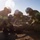 Talisman Sabre 21: U.S., Australian forces perform bilateral fuel training Three firefighters in full turnout gear and white helmets are kneeling on dry, dusty ground working on equipment or debris. The scene appears to be an outdoor training exercise or emergency response situation in an arid environment. Strong backlighting from the sun creates a hazy, high-contrast atmosphere over the scene.