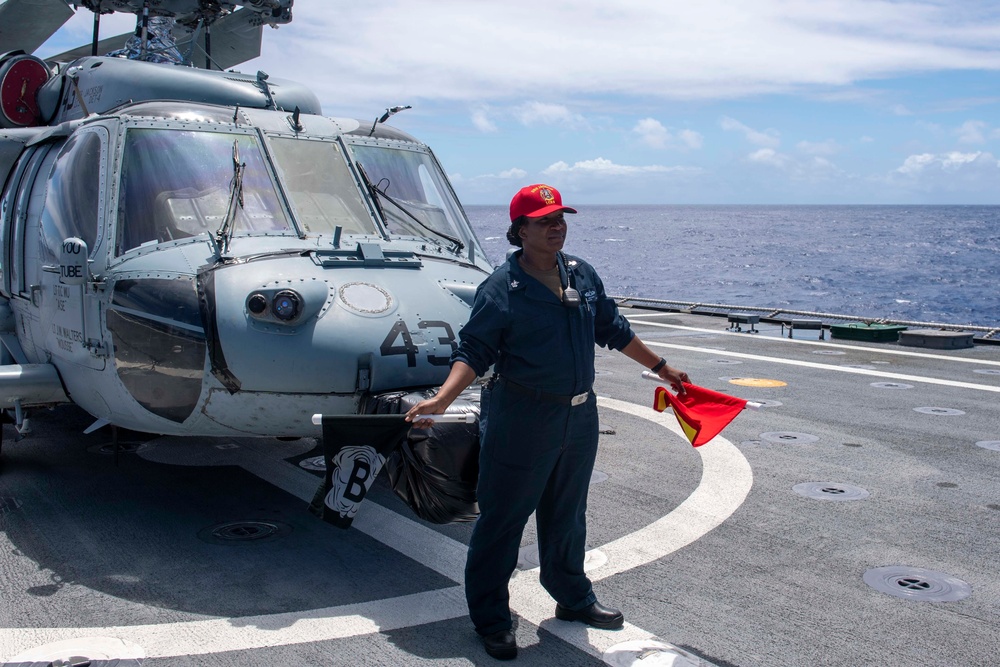 USS Jackson (LCS 6) Sailor waves training firefighting flags