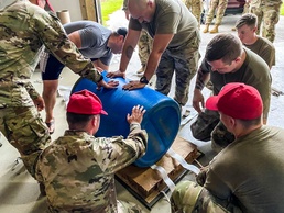 Parachute riggers with 1st SFG (A), 82nd Airborne, US Navy collaborate in building lifesaving apparatus